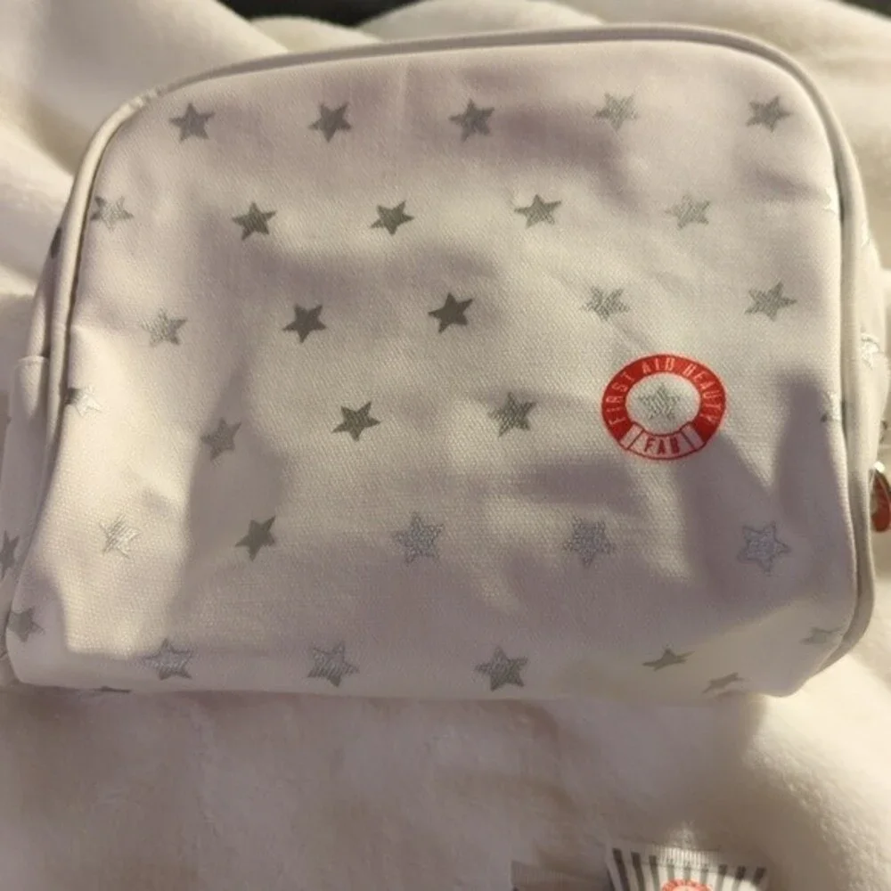 First Aid Beauty Cosmetic bag with three trial size products